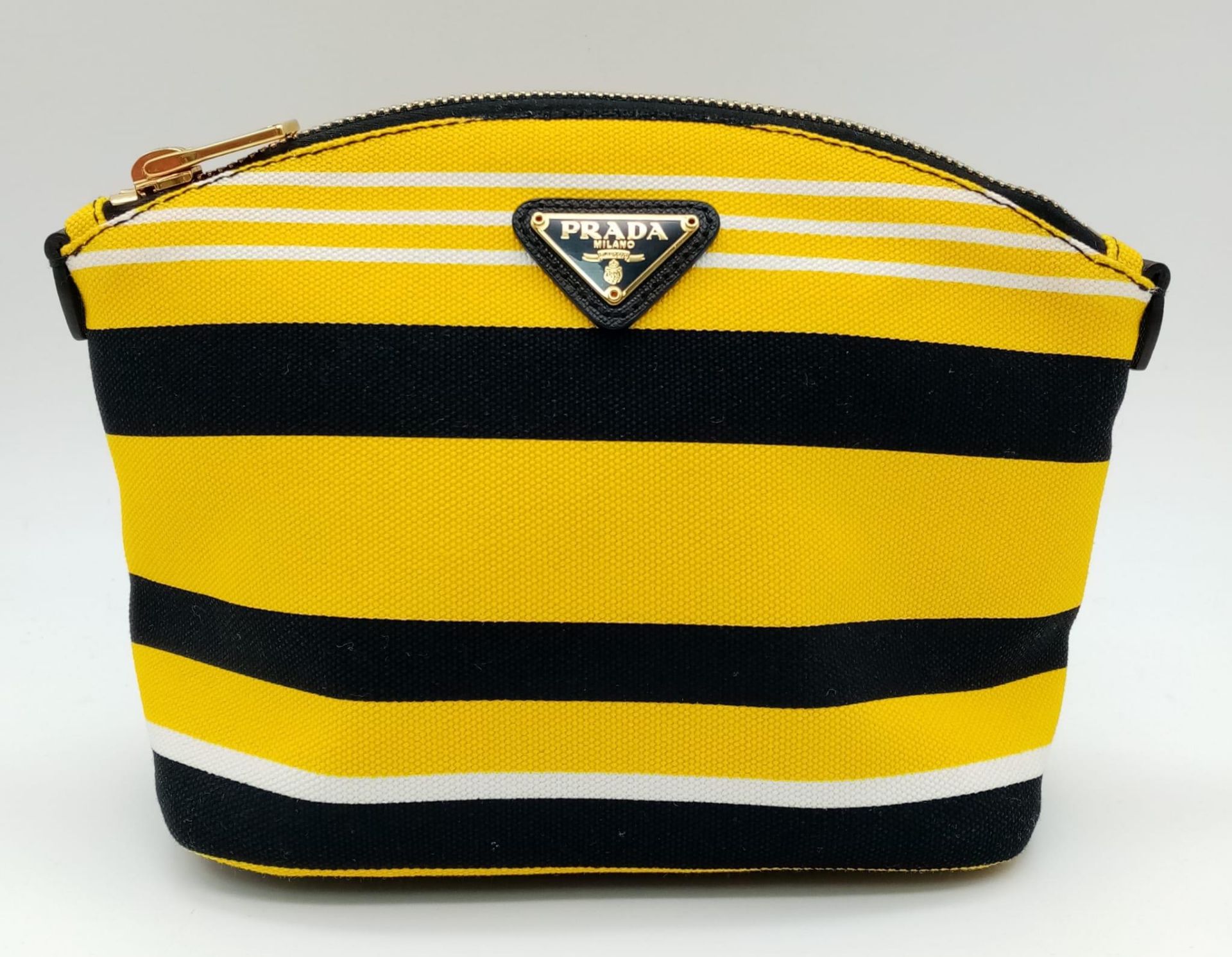 A Prada Yellow, Black and White Pouch. Textile exterior, with gold tone hardware and top zip, and