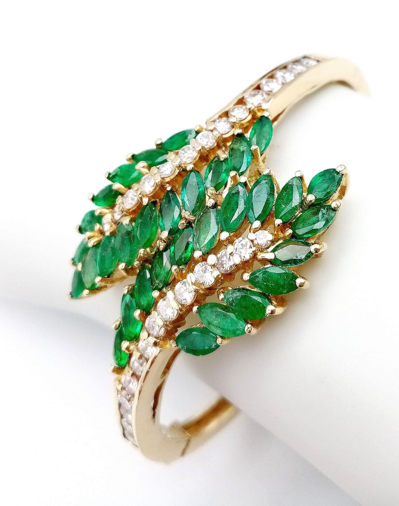 A DIAMOND AND EMERALD LEAF DESIGN BANGLE IN CROSSOVER STYLE SET IN18K GOLD . 33.5gms 10457 - Image 8 of 15