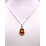 A Rare Sterling Silver, Hand Carved, Amber Pendant Necklace Depicting a Dove in Flight. 46cm