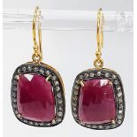 A Pair of Unusual Drop Earrings set with Large Rubies and Diamond Halos - Fish hook fittings in