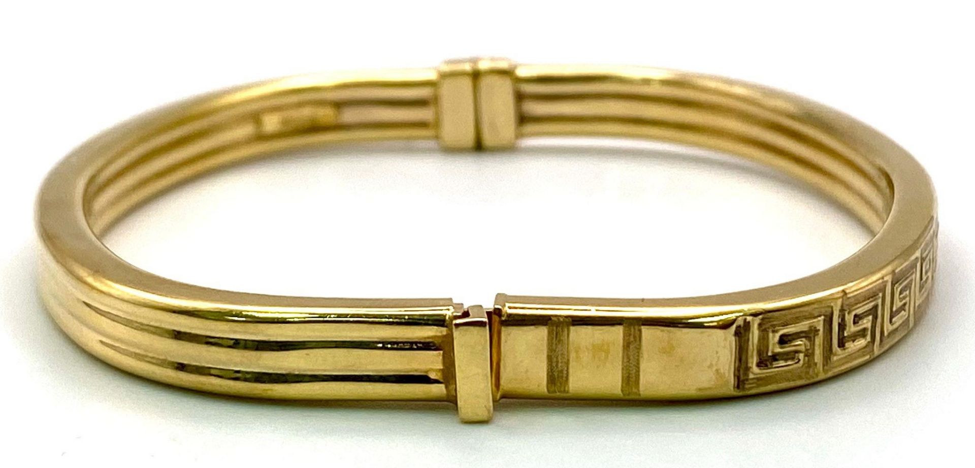 A 9K GOLD ITALIAN DESIGNER HINGED BANGLE WITH GREEK PATTERN ON ONE SIDE . 10.2gms - Image 2 of 5