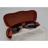 Gucci Sunglasses with Gold and Dark Tortoiseshell Havana frame. Solid brown lens, the pinnacle of