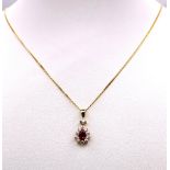 A 9K Gold, Ruby and Diamond Pendant on an 9K Gold Necklace. Teardrop ruby with a diamond halo.