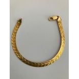 18 carat GOLD BRACELET. Attractive Flat Design having Chased Chevron Pattern. 8.9 grams. 19cm.