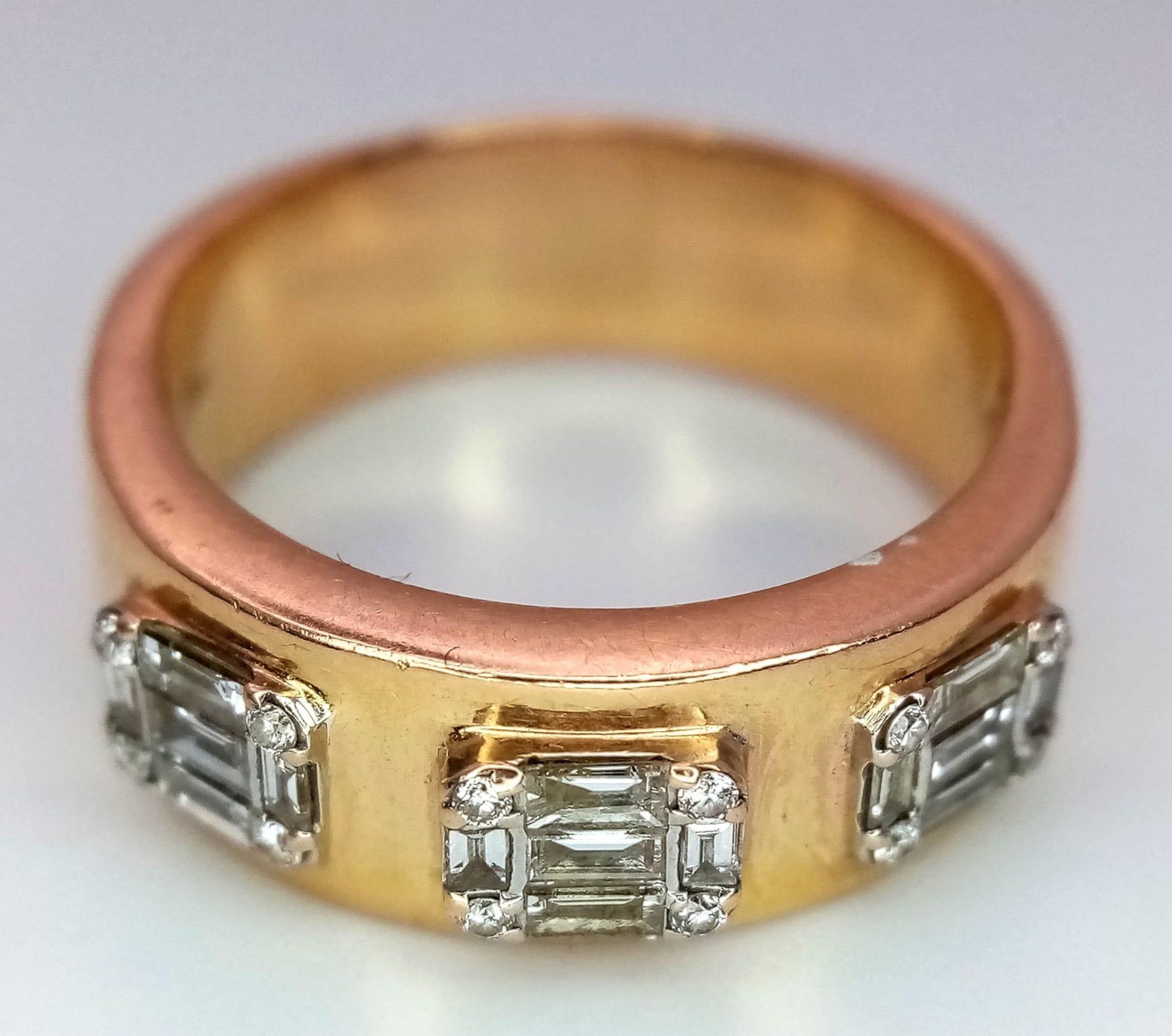 An 18K Rose Gold Diamond Gents Ring. Three sections of baguette and round cut diamonds symbolizing