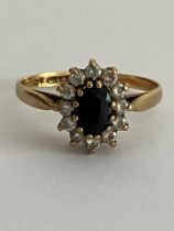 9 carat GOLD and SAPPHIRE RING. Comprising an oval SAPPHIRE set to centre with a clear White