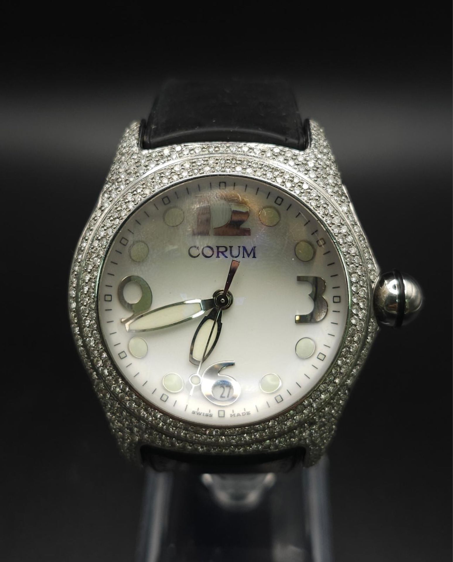 A Corum Boutique Diamond Ladies Watch. Black leather strap. Stainless steel diamond encrusted
