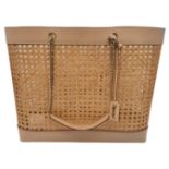 A Saint Laurent Beige Tote Bag. Woven rattan and leather trim exterior. Magnetic closure, gold-toned