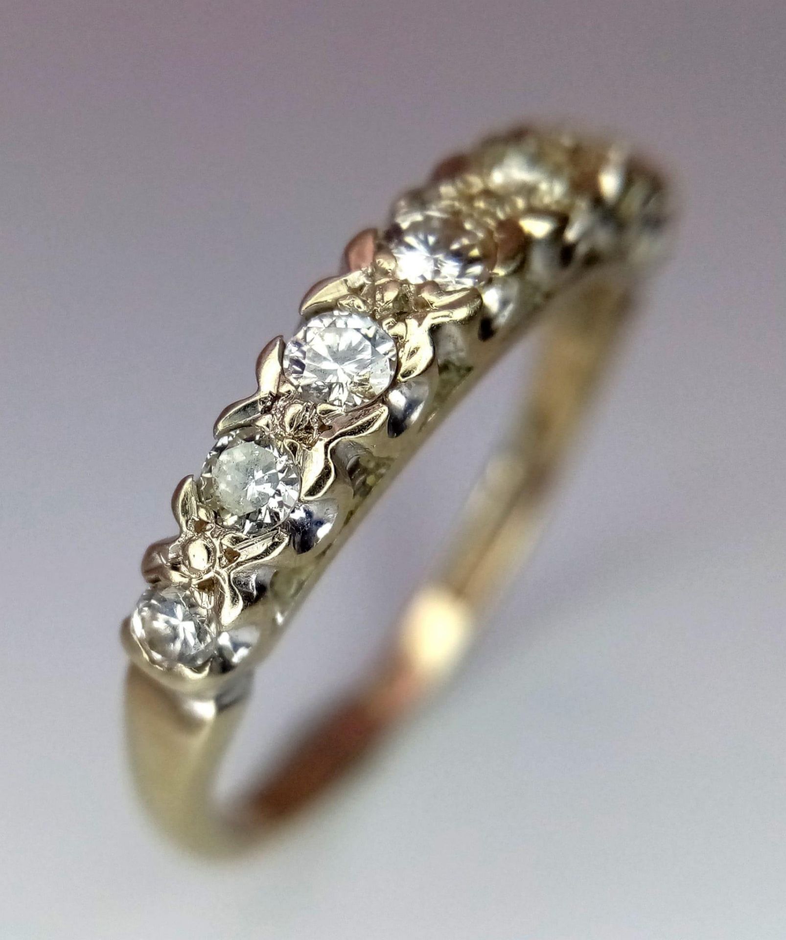 AN 18K GOLD RING WITH EIGHT GRADUATED DIAMONDS TO THE TOP . 3.1gms size O 13691