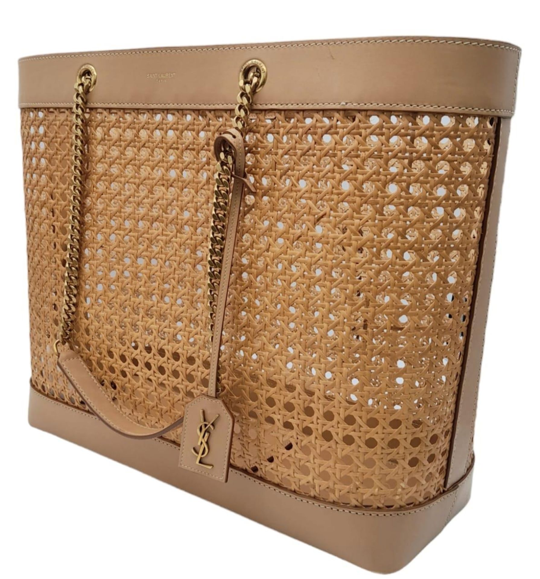 A Saint Laurent Beige Tote Bag. Woven rattan and leather trim exterior. Magnetic closure, gold-toned - Image 2 of 12