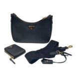 A Prada Black Re-Edition 2005 Mini Bag. Saffiano leather exterior with gold tone hardware, and the