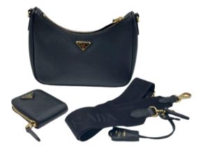 A Prada Black Re-Edition 2005 Mini Bag. Saffiano leather exterior with gold tone hardware, and the