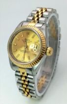 A ROLEX LADIES OYSTER PERPETUAL DATEJUST IN BI-METAL WITH CLASSIC GOLDTONE DIAL . 26mm