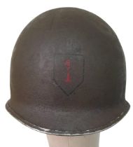 WW2 US Fixed Bale M1 Helmet with insignia of the 1st Infantry Division. “The Big Red 1”.