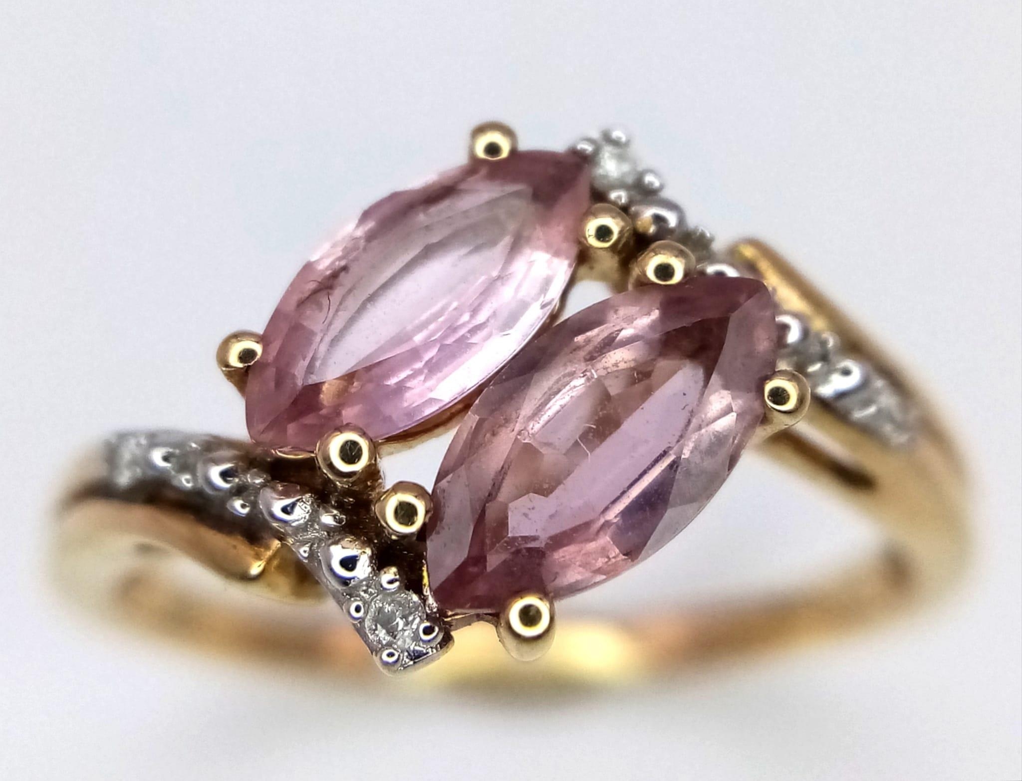 A 10k Yellow Gold, Amethyst and Diamond Crossover Ring. Size N. 2.17g total weight.