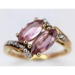A 10k Yellow Gold, Amethyst and Diamond Crossover Ring. Size N. 2.17g total weight.