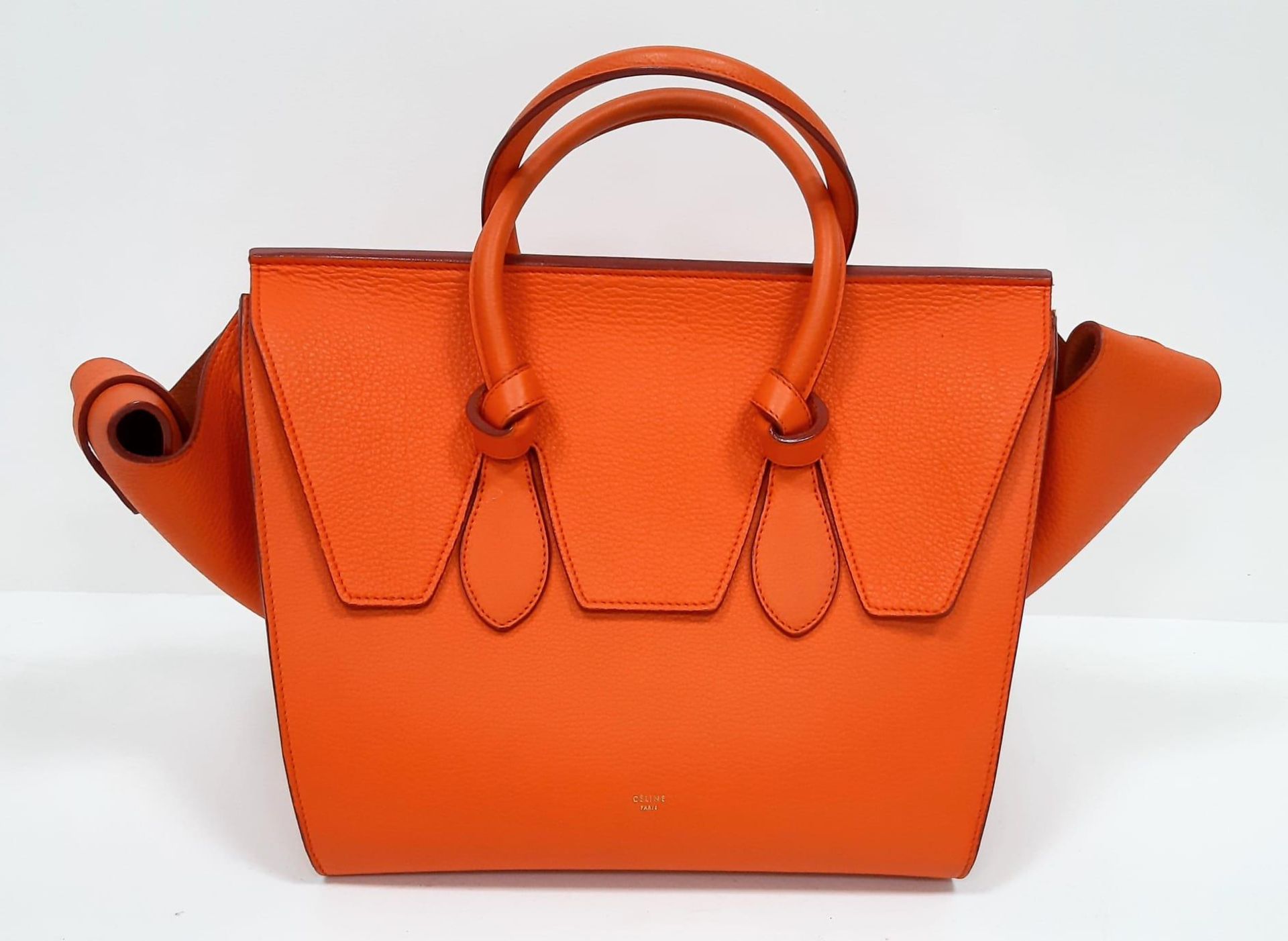 Celine Orange Tie Bag. Grained leather exterior, vibrant orange colouring. Made in Italy, it has a