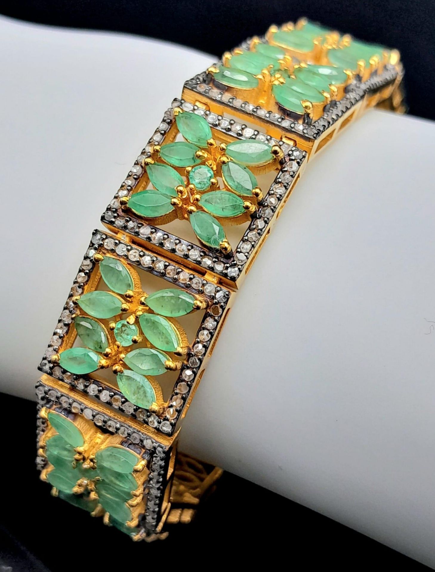An Emerald and Diamond Gemstone Tennis Bracelet set in Gilded 925 Silver. Floral design. Old cut