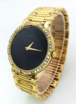 A PIAGET 18K GOLD LADIES DRESS WATCH WITH DIAMOND BEZEL , GOLD HANDS ON A BLACK DIAL , QUARTZ