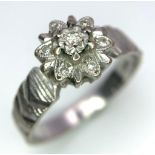 A Vintage 18K White Gold Diamond Floral Ring. Ridged effect on shoulders. Size L/M. 3.36g total