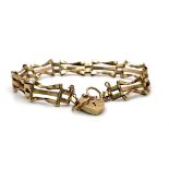 A Vintage 9K Yellow Gold 'Bow Tie' Gate Bracelet - with heart clasp and safety chain. 16cm. 6.75g
