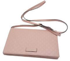 A Gucci Dusty Pink Monogram Crossbody Bag. Leather exterior, with a zipped outer pocket and a