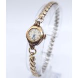 A Vintage Bimesa 17 Jewel 18K Gold Cased Mechanical Watch. Expandable gilded bracelet. 18k gold