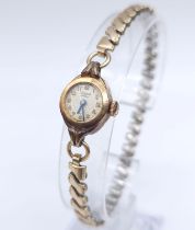 A Vintage Bimesa 17 Jewel 18K Gold Cased Mechanical Watch. Expandable gilded bracelet. 18k gold