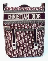 A Christian Dior Burgundy Monogram Backpack. Canvas exterior, with silver toned hardware, flat