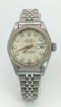 A LADIES ROLEX OYSTER PERPETUAL DATEJUST IN STAINLESS STEEL WITH DIAMOND NUMERALS AND