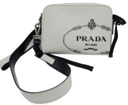 Prada Top Zip Casual Bag. Quality leather exterior with Prada Milano detail on front. Comes with a