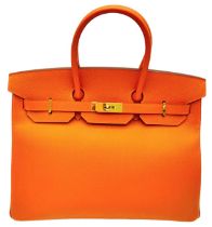 Hermès Orange Togo Birkin Handbag. Iconic Orange paired with gold toned hardware is a brilliant