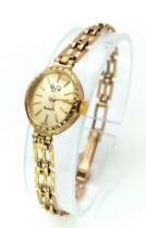 A Vintage 9K Gold RJW Ladies Watch. 9k gold link bracelet. 9K gold oval case - 15mm. Gold tone dial.