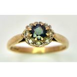 A 9K Yellow Gold Sapphire and Diamond Ring. Central sapphire with diamond halo. Size O. 2.28g