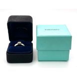 A platinum TIFFANY & CO diamond solitaire ring with the original presentation inner and outer boxes.