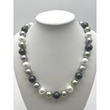 A Four Colour South Sea Pearl Shell 12mm Bead Necklace. White, green, silver and grey. 44cm necklace