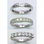 A Trio of Sparkly Silver Rings. Three various white stone designs. Two size N and the one with a