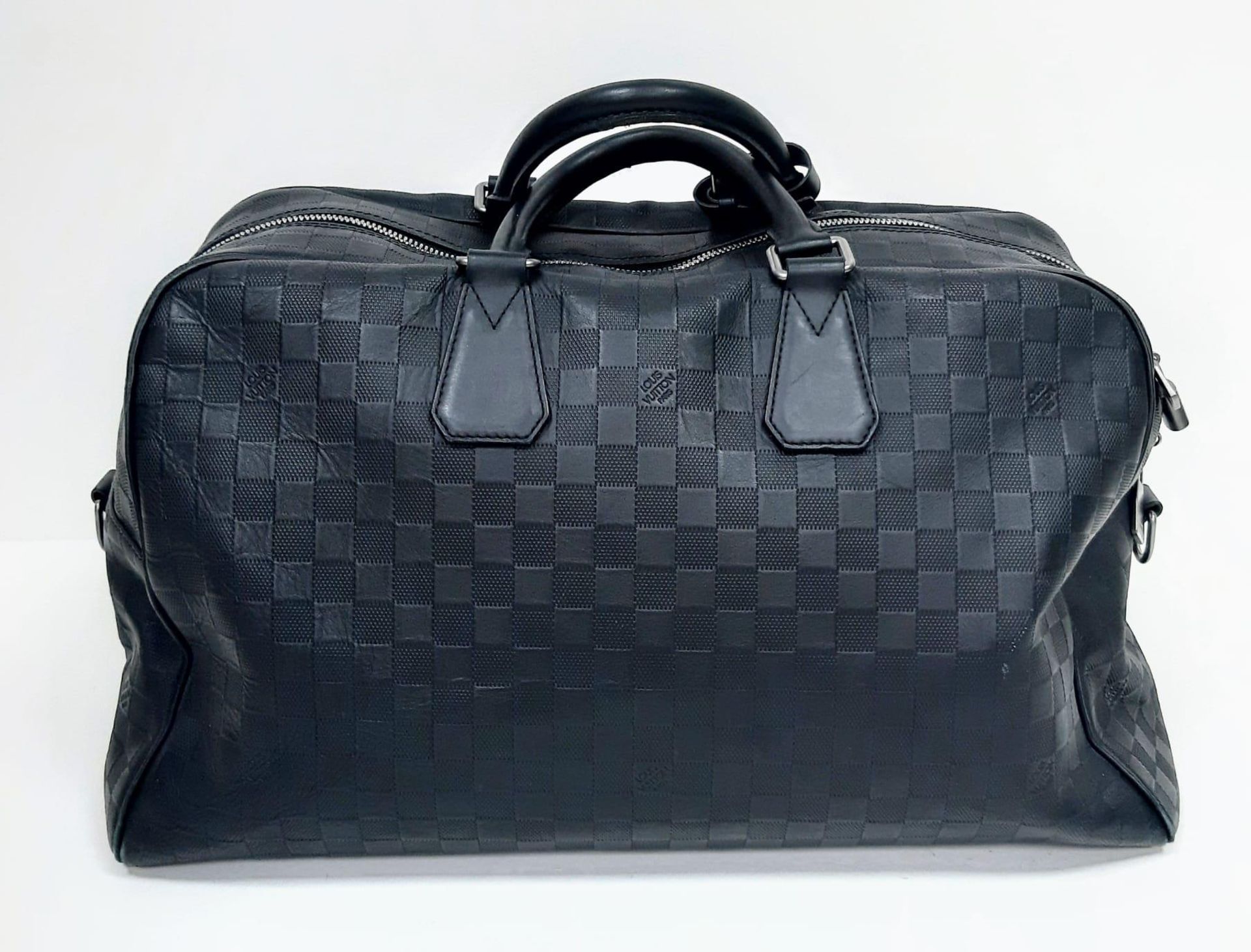 Louis Vuitton Keepall Luggage Bag. Black leather exterior with Silver toned hardware and typical