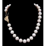 A very glamorous vintage pearl necklace with a beautiful yellow gold asymmetric clasp loaded with