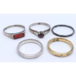 A collection of five silver solitare and band rings. One of them is gilded silver and the other