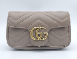 A Gucci Mocha Marmont Mini Crossbody Bag. Matelassé leather exterior, with gold toned hardware and