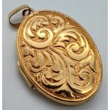 A 9K Yellow Gold Oval Locket Pedant with Scroll Decoration. 3.5cm. 3.31g total weight.