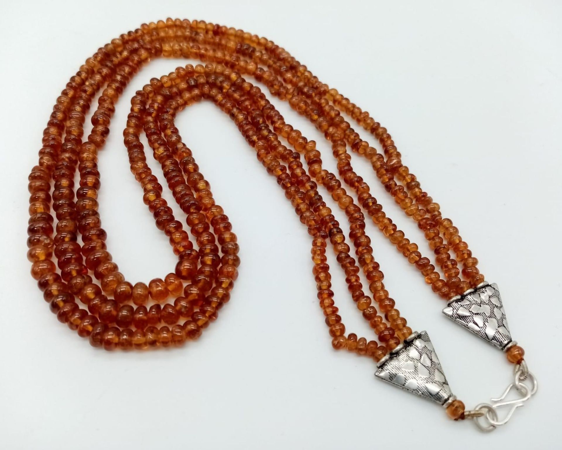 A Three Row Hessonite Garnet Small Rondelle Bead Necklace. 245ctw. 925 Silver Clasp. 40-46cm length.
