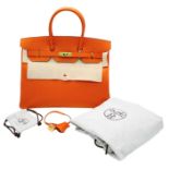 Hermès Orange Togo Birkin Handbag. Iconic Orange paired with gold toned hardware is a brilliant