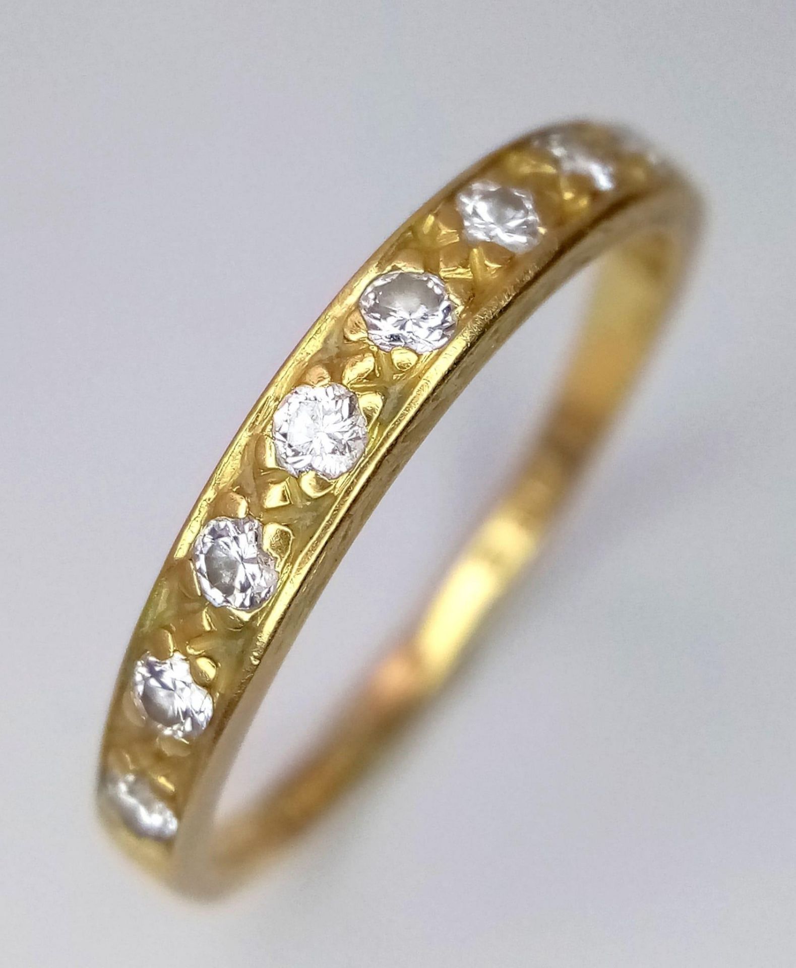 An 18K Yellow Gold Diamond Set Band Ring. Size P, 0.20ctw, 2.2g total weight.