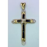 A 9 K yellow gold cross with sapphires and diamonds. Length (with bail): 35 mm, weight: 1.3 g.
