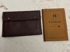 A German WW2 Waffen SS Soldbuch in a Wehrpas Wallet. The Soldbuch (standard military issue) served