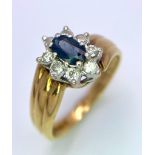 A designer 18K Yellow Gold Ring with stunning central Sapphire surrounded by a halo of Diamonds.