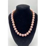 A Charming Pink South Sea Pearl Shell Bead Necklace. 12mm shell beads. 44cm necklace length. Heart