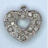 A 9K WHITE GOLD DOUBLE SIDED 0.35CT DIAMOND SET HEART PENDANT. TOTAL WEIGHT 1.4G